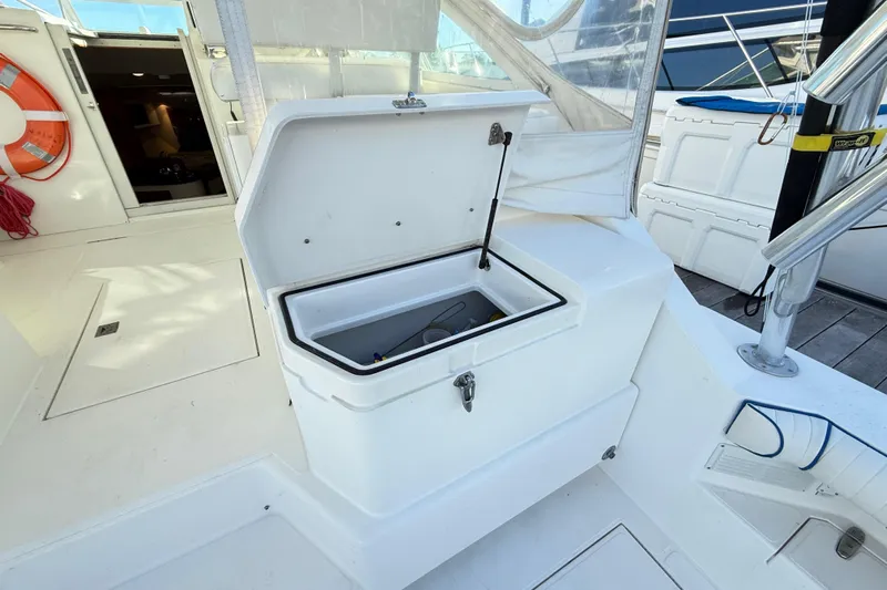 Sea Dated Yacht Photos Pics Open storage compartment on 1996 Cabo 35 boat deck, with visible life preserver nearby.