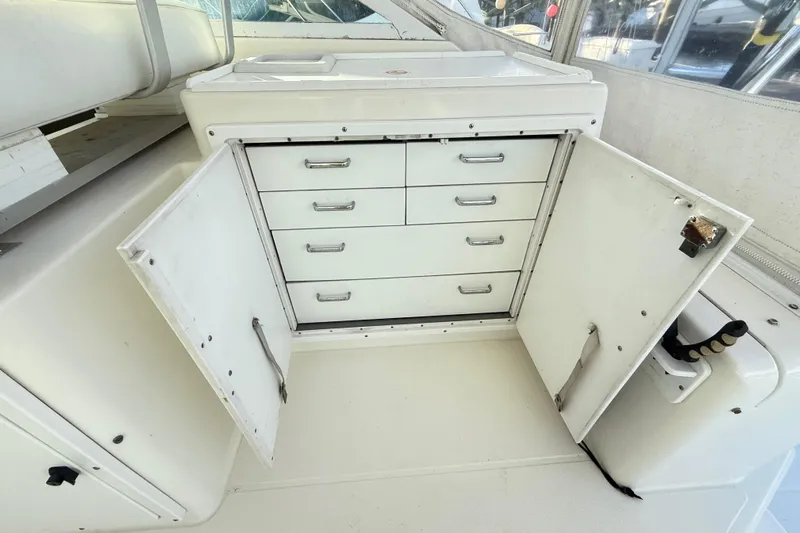 Sea Dated Yacht Photos Pics Open storage cabinet with drawers on a 1996 Cabo 35 boat.