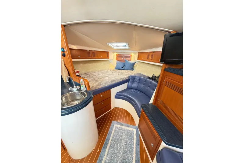 Sea Dated Yacht Photos Pics Luxurious interior of a 1996 Cabo 35 boat featuring cozy seating and elegant wood finishes.