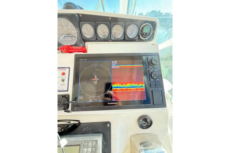 Sea Dated Yacht Photos Pics 1996 Cabo 35 boat dashboard with Garmin navigation display and gauges.