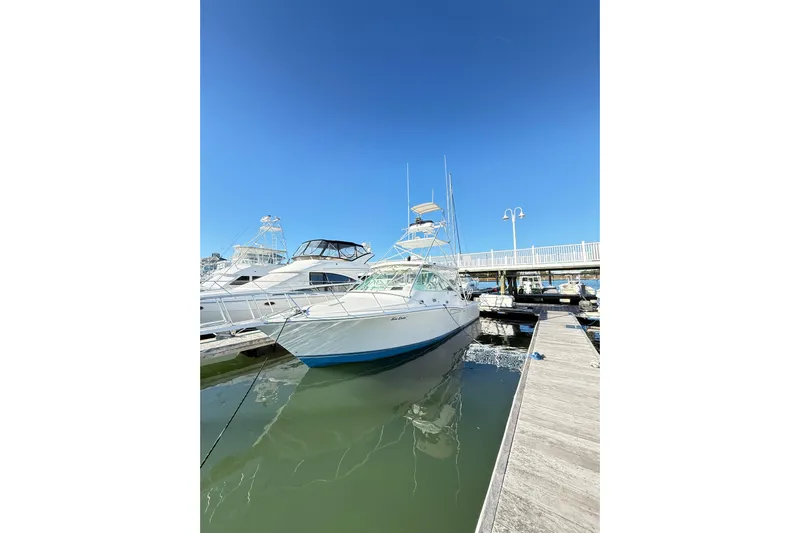 Sea Dated Yacht Photos Pics 1996 Cabo 35 boat docked at marina under clear blue sky.