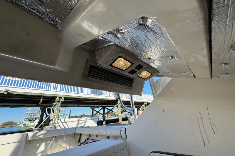 Sea Dated Yacht Photos Pics Interior view of a 1996 Cabo 35 boat with overhead lighting and insulation.