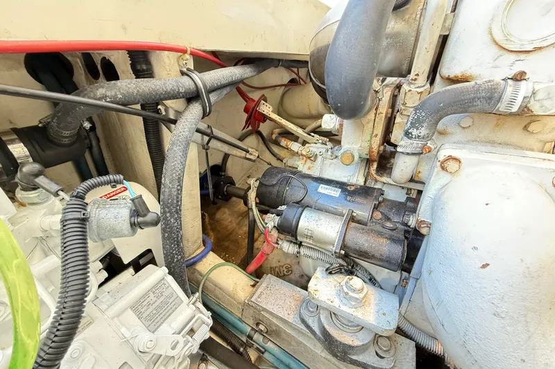 Sea Dated Yacht Photos Pics Engine compartment of a 1996 Cabo 35 boat, showing various mechanical components and hoses.