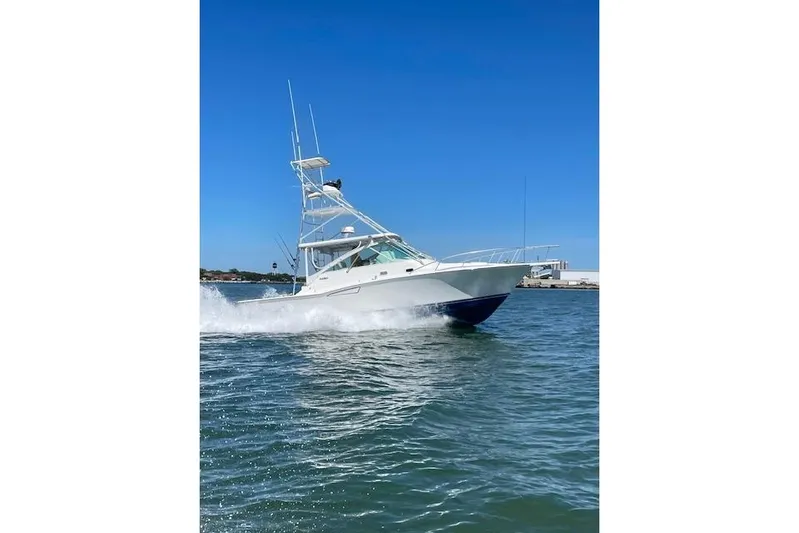 Sea Dated Yacht Photos Pics 1996 Cabo 35 boat cruising on open water under clear blue sky.
