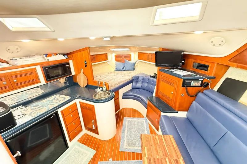 Sea Dated Yacht Photos Pics Interior of a 1996 Cabo 35 yacht with kitchen and seating area.