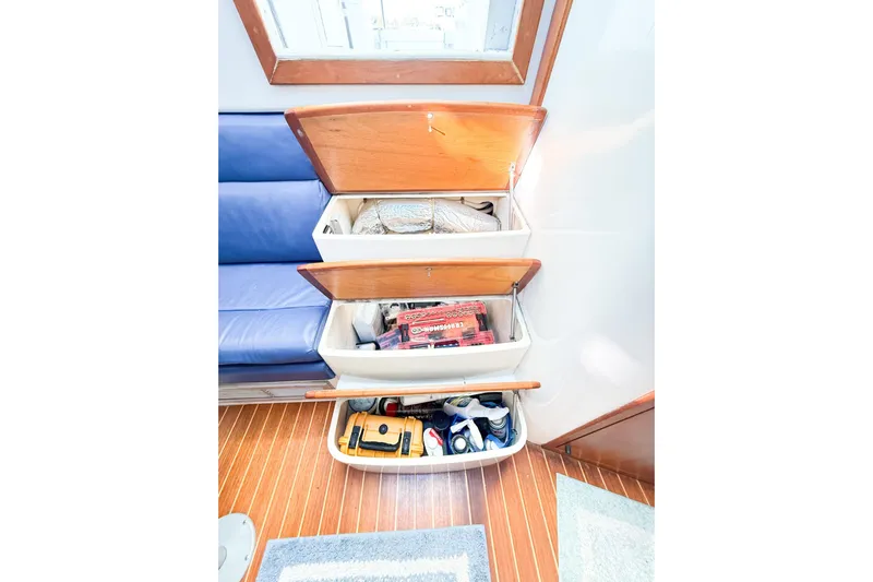 Sea Dated Yacht Photos Pics Interior of a 1996 Cabo 35 boat with storage compartments.
