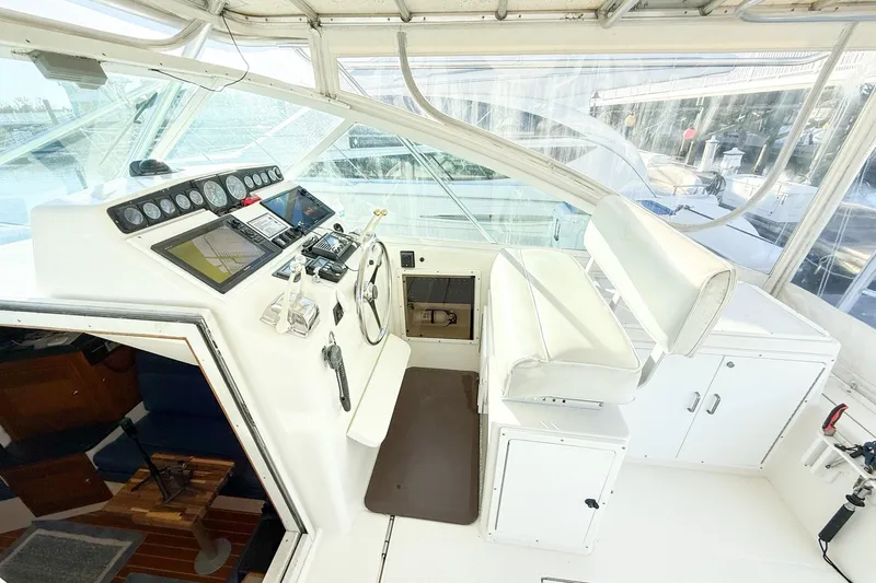 Sea Dated Yacht Photos Pics Interior view of a 1996 Cabo 35 boat with helm console.