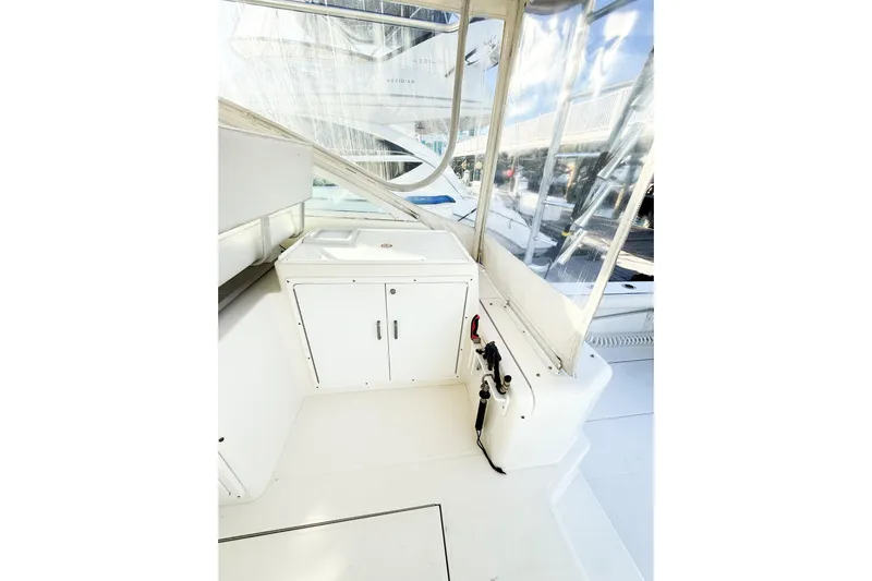 Sea Dated Yacht Photos Pics Interior of a 1996 Cabo 35 yacht with white cabinetry.