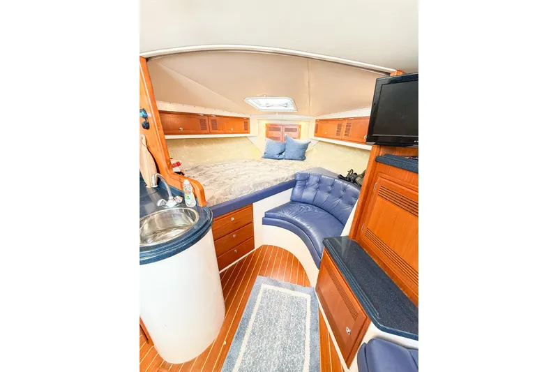 Sea Dated Yacht Photos Pics Interior of a 1996 Cabo 35 yacht with bed and seating area.