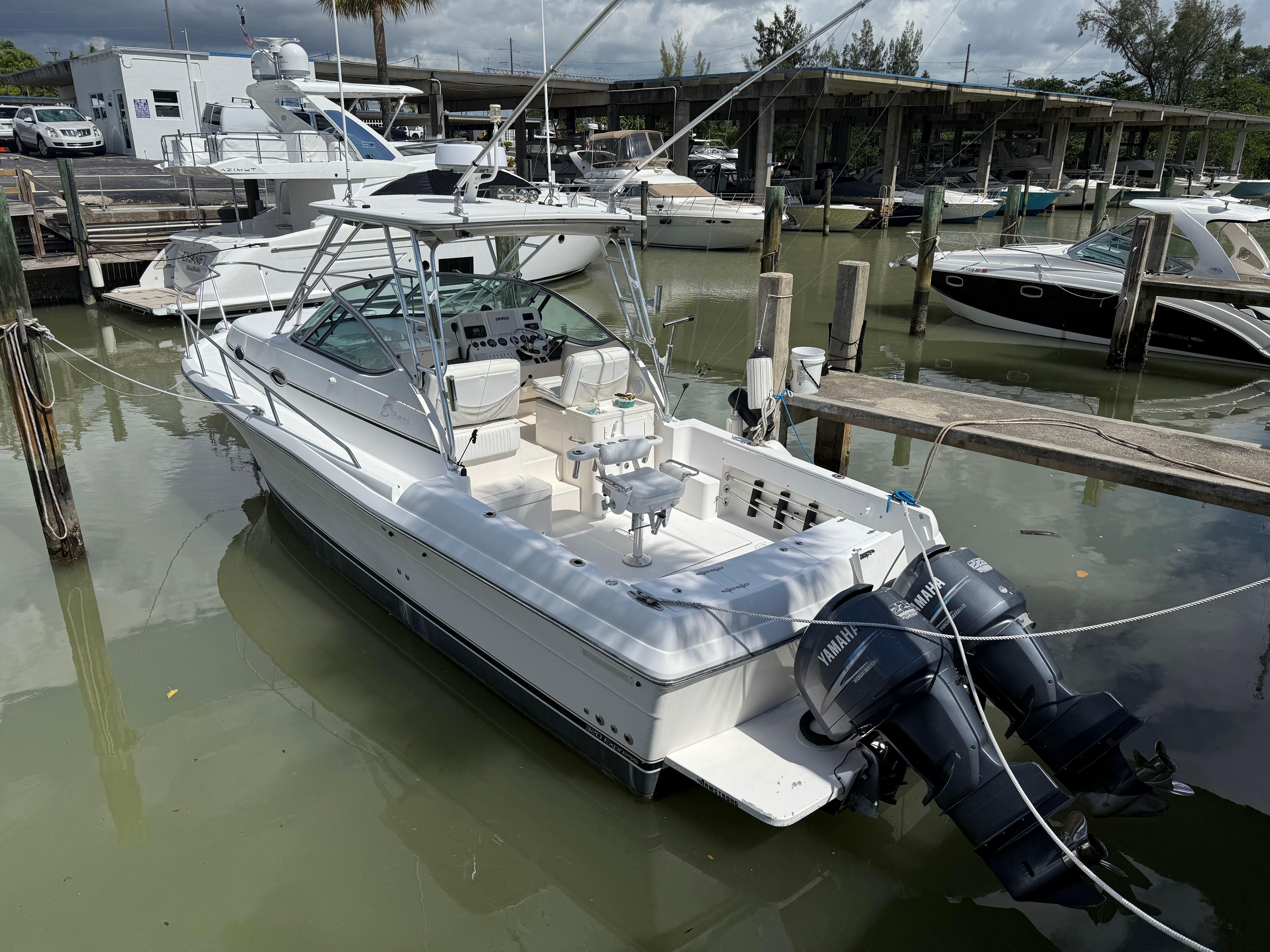 2004 Stamas 320 Express boat docked with dual Yamaha outboard engines.
