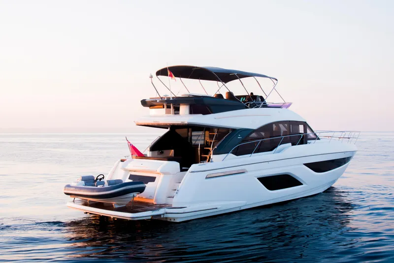 Valluga Yacht Photos Pics Luxurious 2018 Bavaria R55 yacht cruising on calm waters at sunset.