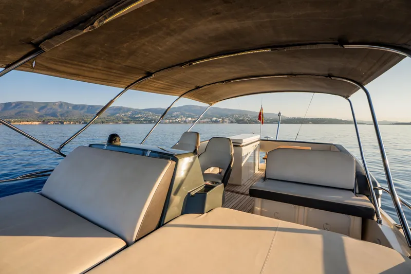 Valluga Yacht Photos Pics Luxurious 2018 Bavaria R55 yacht interior with scenic ocean view and mountains in the background.