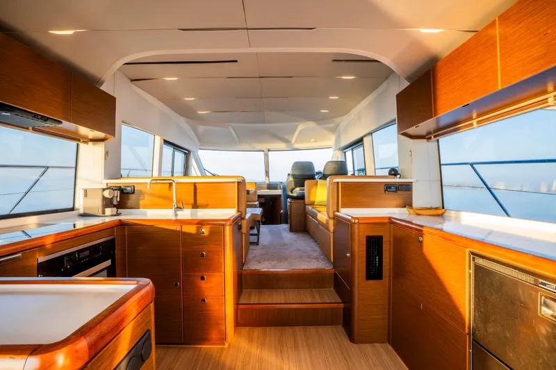 Valluga Yacht Photos Pics Luxurious interior of 2018 Bavaria R55 yacht with modern kitchen and seating area.