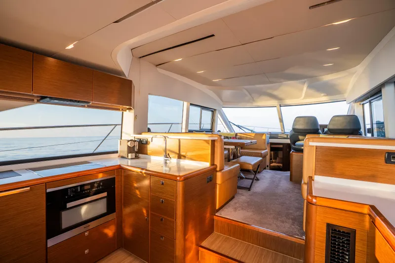Valluga Yacht Photos Pics Luxurious interior of 2018 Bavaria R55 yacht with modern kitchen and seating area.