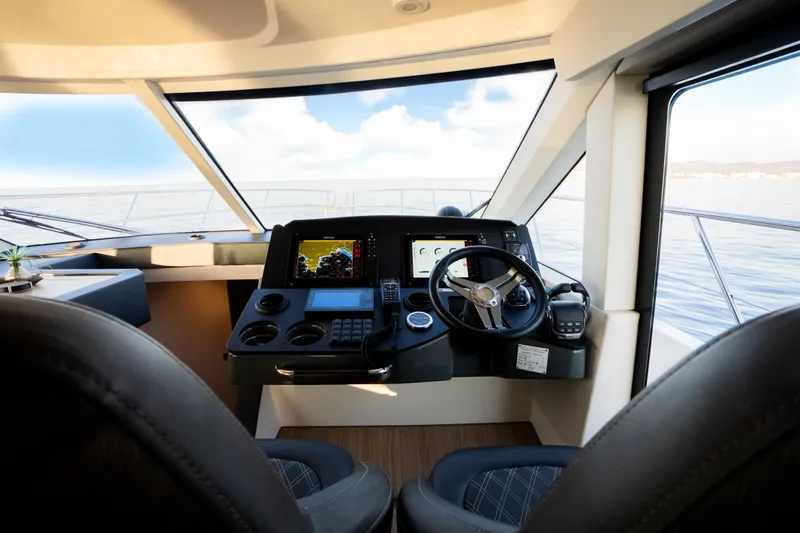 Valluga Yacht Photos Pics Helm of 2018 Bavaria R55 yacht with modern navigation equipment and panoramic view.