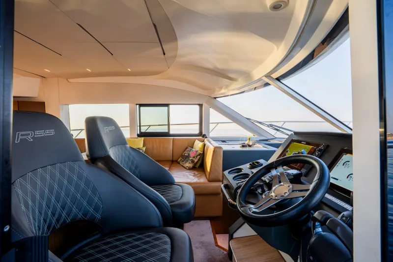 Valluga Yacht Photos Pics Luxurious interior of 2018 Bavaria R55 yacht with leather seating and modern navigation controls.