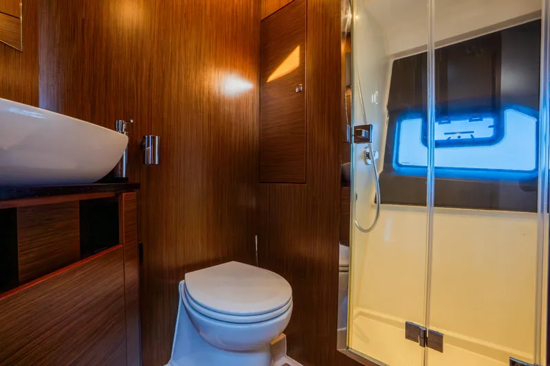 Valluga Yacht Photos Pics Luxurious bathroom in 2018 Bavaria R55 yacht with wooden finish and modern fixtures.