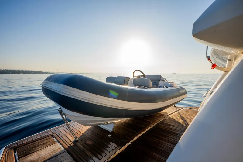 Valluga Yacht Photos Pics Inflatable boat on Bavaria R55 yacht, 2018 model, at sunrise over calm sea.