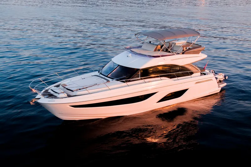 Valluga Yacht Photos Pics 2018 Bavaria R55 yacht cruising on calm blue waters at sunset.