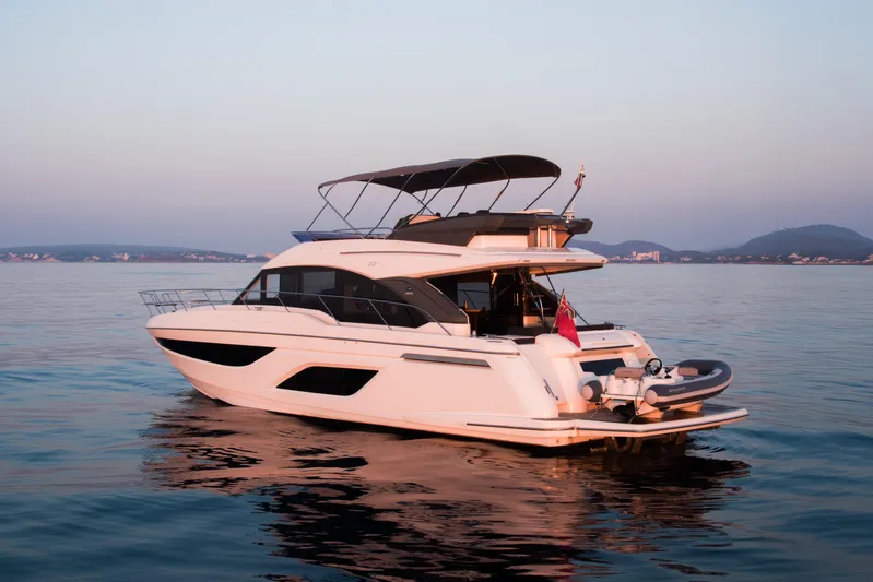 Valluga Yacht Photos Pics 2018 Bavaria R55 yacht on calm water at sunset, featuring sleek design and modern amenities.
