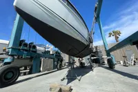 Saxdor 320 GTO 2023 boat on lift at marina, clear sky background.