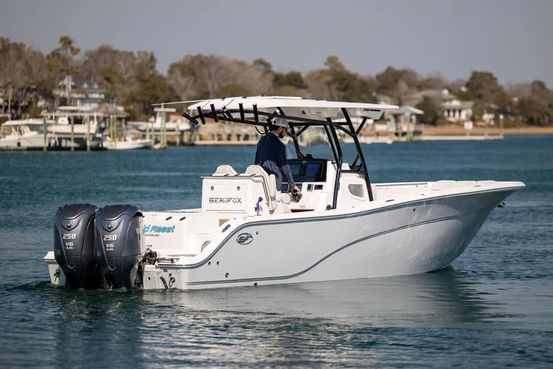  Yacht Photos Pics 2023 Sea Fox 288 Commander boat cruising on a calm lake with dual engines.