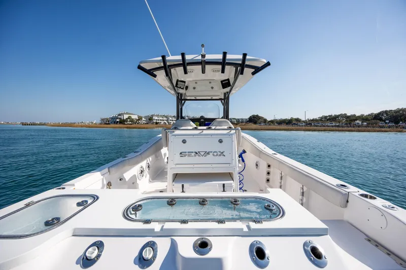  Yacht Photos Pics 2023 Sea Fox 288 Commander boat on calm water, showcasing spacious deck and modern design.