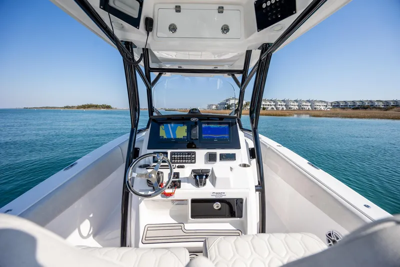  Yacht Photos Pics 2023 Sea Fox 288 Commander boat dashboard with dual screens on calm water.
