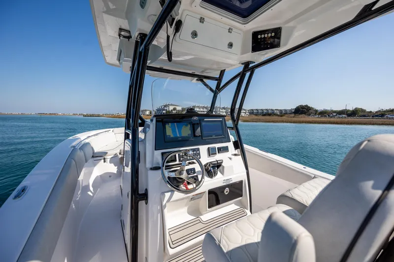  Yacht Photos Pics 2023 Sea Fox 288 Commander boat interior with modern helm and seating on calm water.