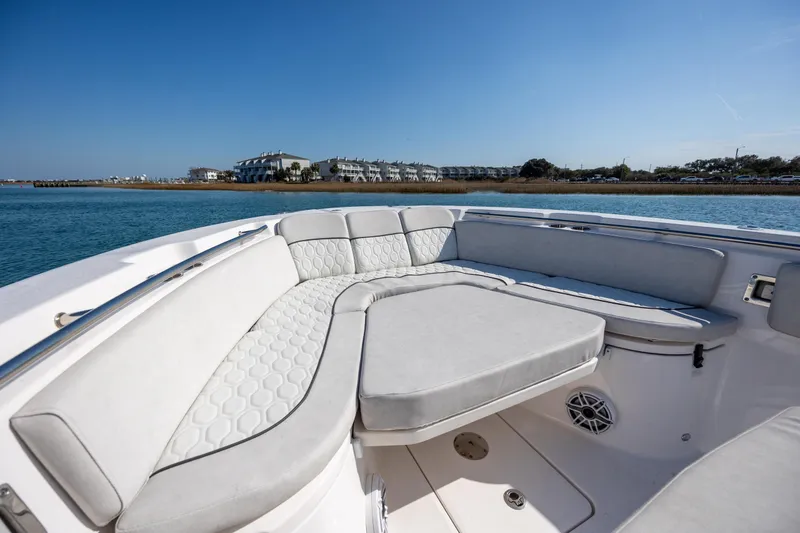  Yacht Photos Pics 2023 Sea Fox 288 Commander boat interior with cushioned seating, on a sunny day.