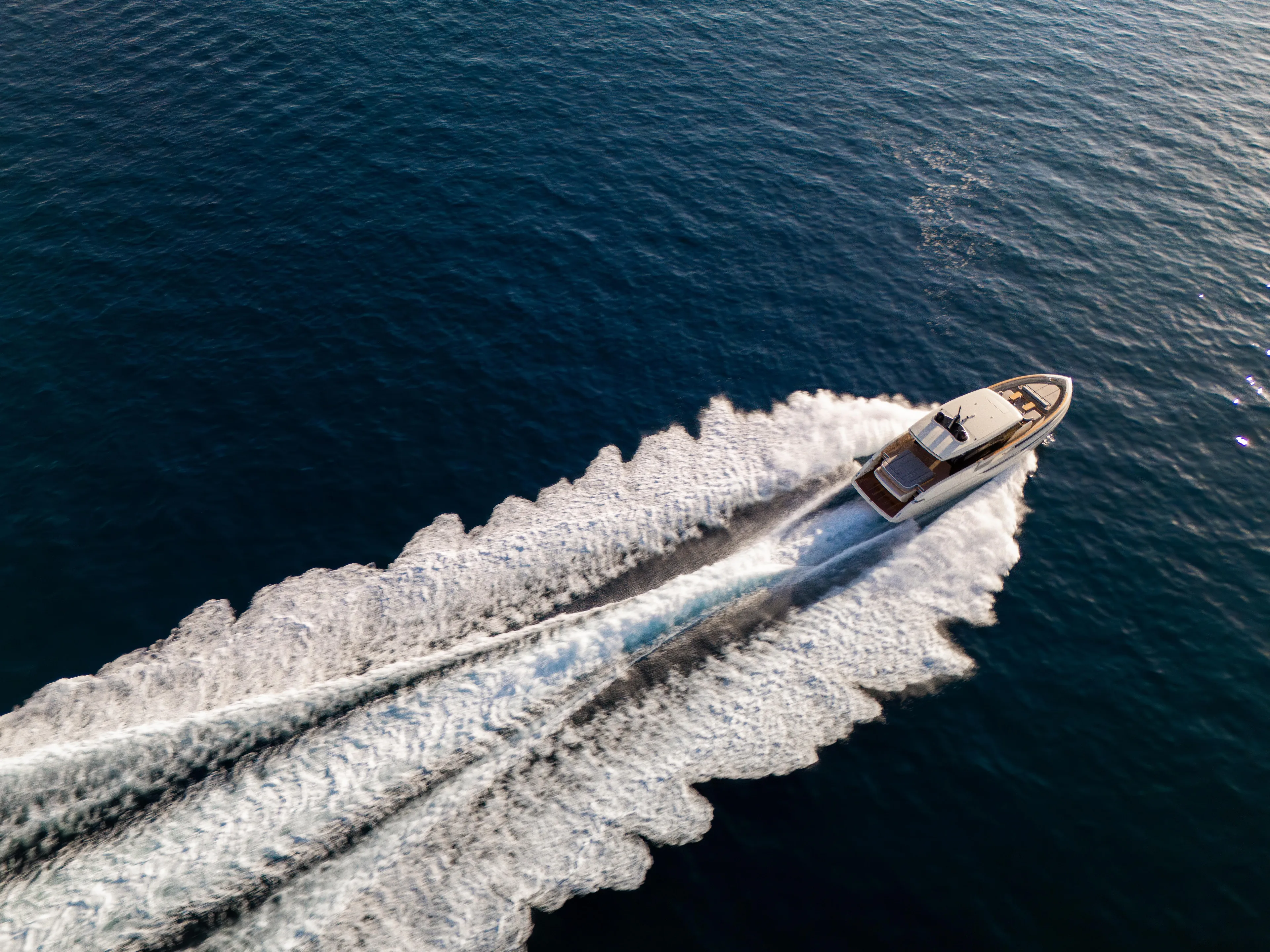  Yacht Photos Pics Aerial view of 2025 Invictus ST550 yacht cruising on open water.