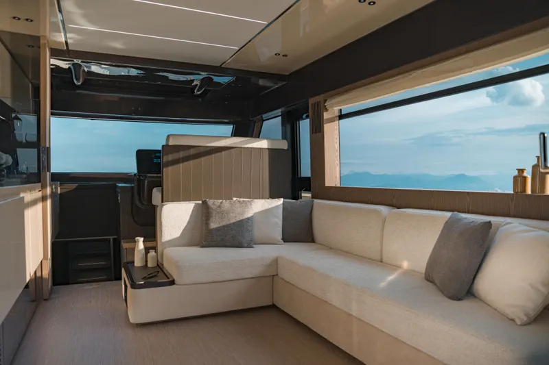 Yacht Photos Pics Luxurious interior of 2025 Invictus ST550 yacht with modern seating and panoramic window views.