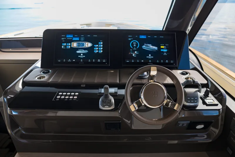  Yacht Photos Pics Helm of 2025 Invictus ST550 yacht with dual digital displays and modern controls.
