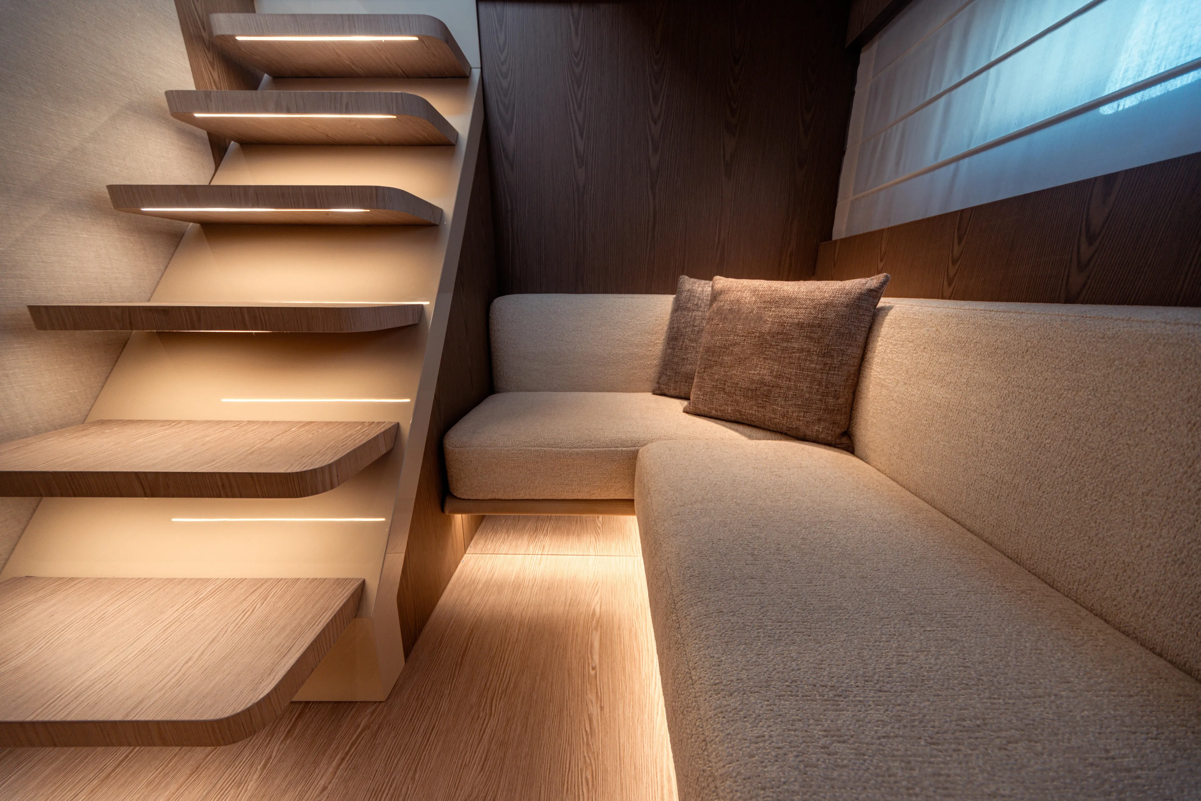  Yacht Photos Pics Luxurious interior of 2025 Invictus ST550 yacht with modern staircase and cozy seating area.