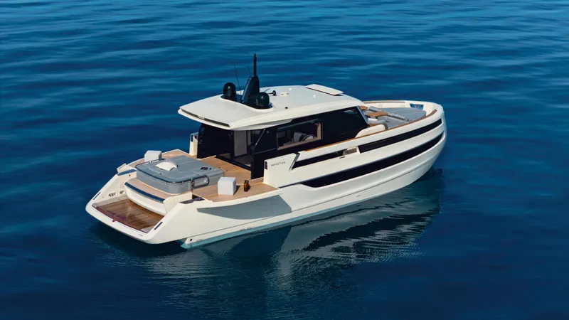  Yacht Photos Pics 2025 Invictus ST550 yacht on calm blue water, showcasing sleek design and luxury features.