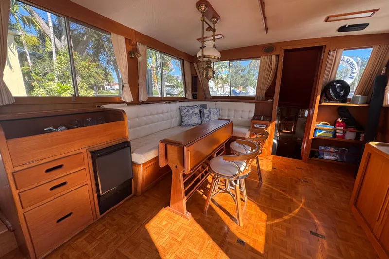Good Enough Yacht Photos Pics Interior of 1990 Grand Banks 46 Classic yacht with wood finish and seating area.