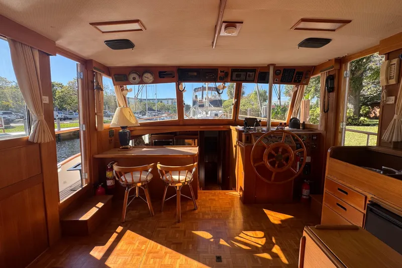Good Enough Yacht Photos Pics Interior of a 1990 Grand Banks 46 Classic yacht with wooden furnishings and helm.