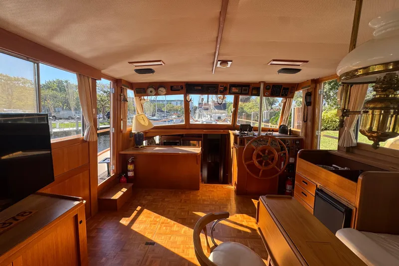 Good Enough Yacht Photos Pics Interior of 1990 Grand Banks 46 Classic yacht with wooden helm and vintage decor.