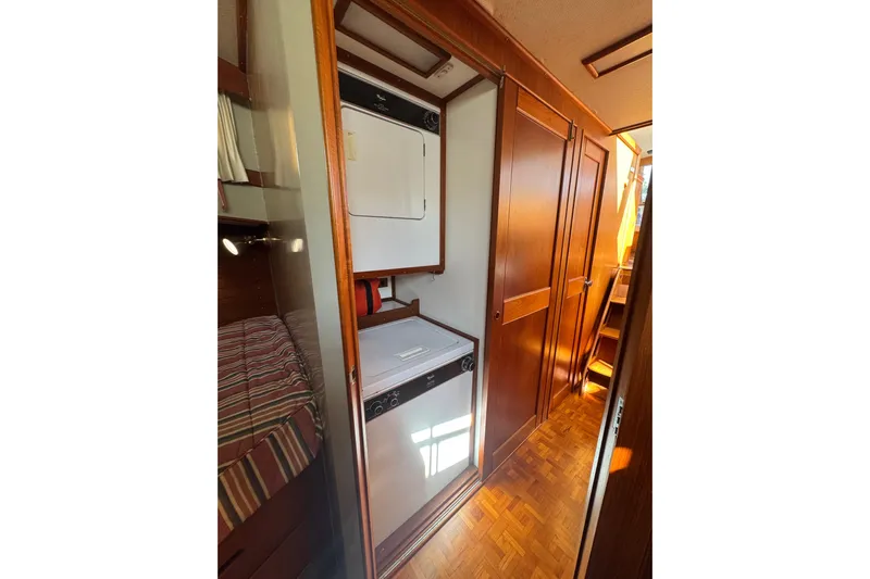 Good Enough Yacht Photos Pics 1990 Grand Banks 46 Classic yacht interior with wood paneling and laundry area.