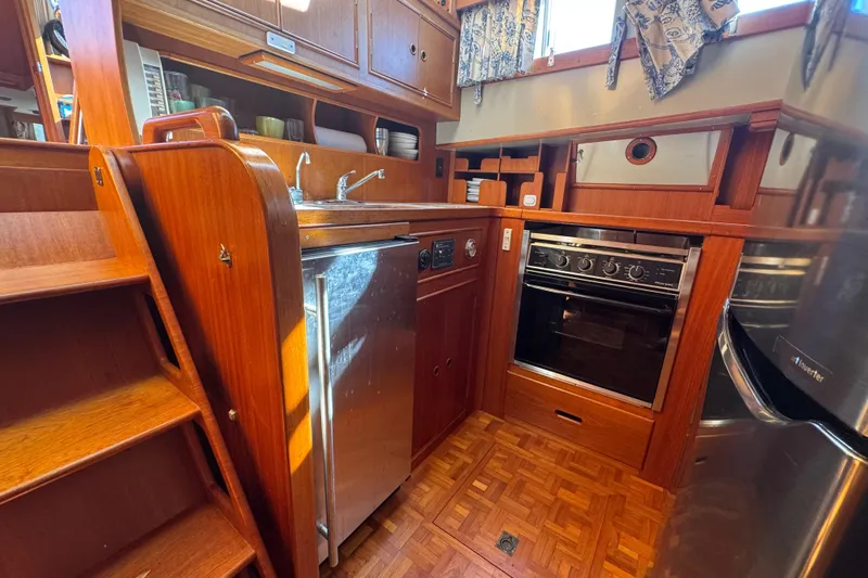 Good Enough Yacht Photos Pics 1990 Grand Banks 46 Classic yacht kitchen with wood cabinetry and stainless steel appliances.