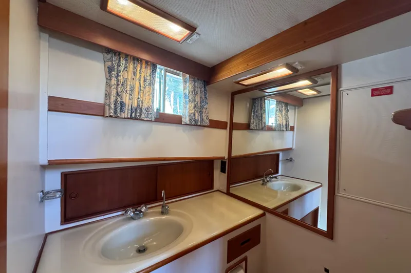 Good Enough Yacht Photos Pics Bathroom interior of 1990 Grand Banks 46 Classic yacht with sink and mirror.