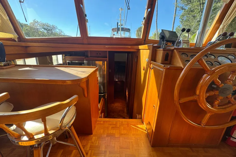 Good Enough Yacht Photos Pics Interior of 1990 Grand Banks 46 Classic yacht with wooden helm and seating area.