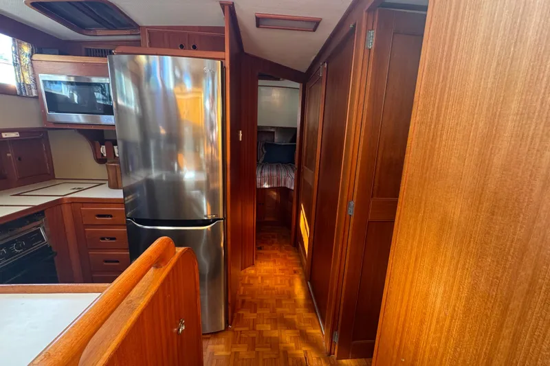 Good Enough Yacht Photos Pics 1990 Grand Banks 46 Classic yacht interior with wood finish and modern kitchen appliances.