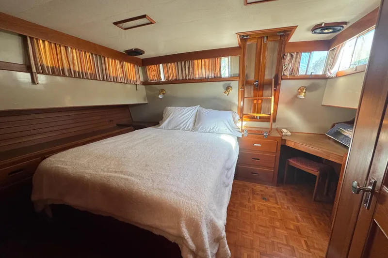 Good Enough Yacht Photos Pics Cozy bedroom in 1990 Grand Banks 46 Classic yacht with wood accents and natural light.