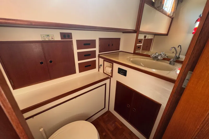 Good Enough Yacht Photos Pics Bathroom interior of 1990 Grand Banks 46 Classic yacht with wood cabinetry and sink.