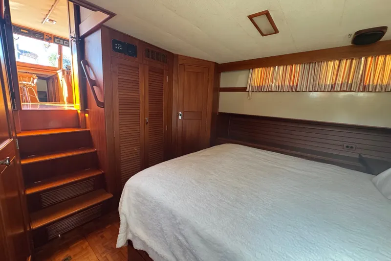 Good Enough Yacht Photos Pics Cozy bedroom interior of 1990 Grand Banks 46 Classic yacht with wooden accents and stairs.
