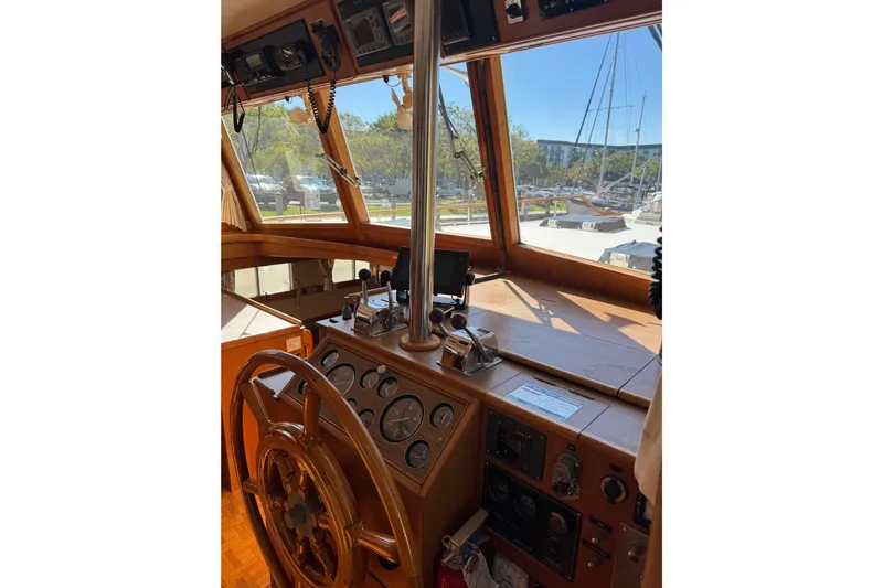 Good Enough Yacht Photos Pics Helm of 1990 Grand Banks 46 Classic yacht with wooden wheel and navigation instruments.