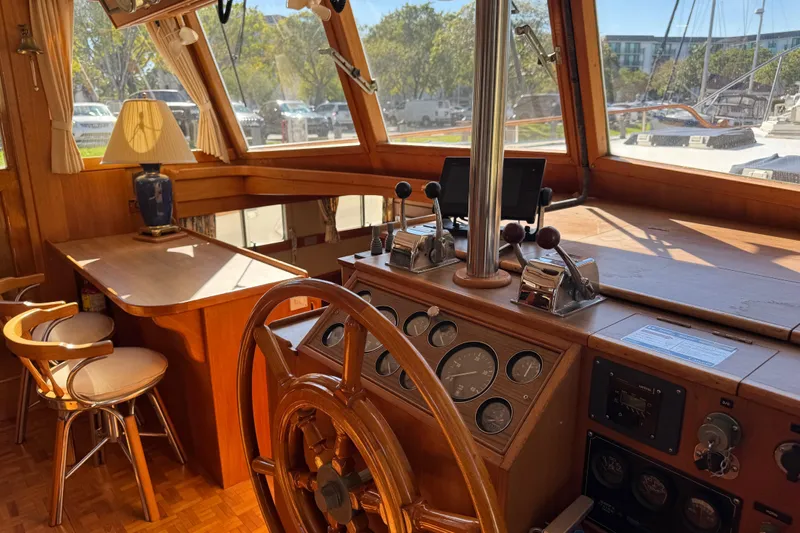 Good Enough Yacht Photos Pics Interior of 1990 Grand Banks 46 Classic yacht with wooden helm and seating area.