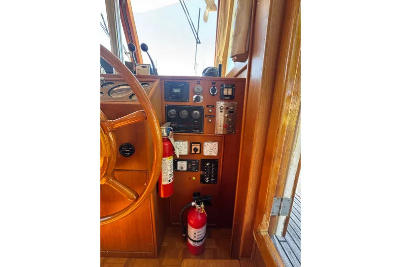 Good Enough Yacht Photos Pics Helm of 1990 Grand Banks 46 Classic with wooden wheel and control panel.