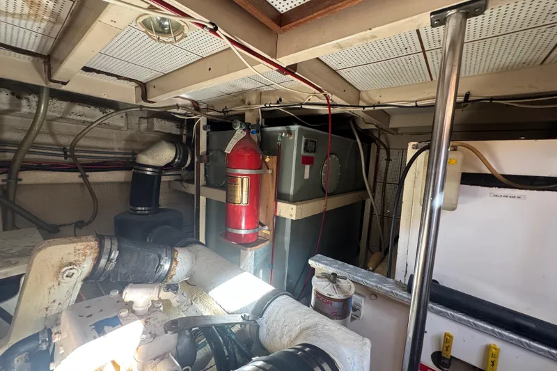 Good Enough Yacht Photos Pics Engine room of 1990 Grand Banks 46 Classic with fire extinguisher and mechanical components.